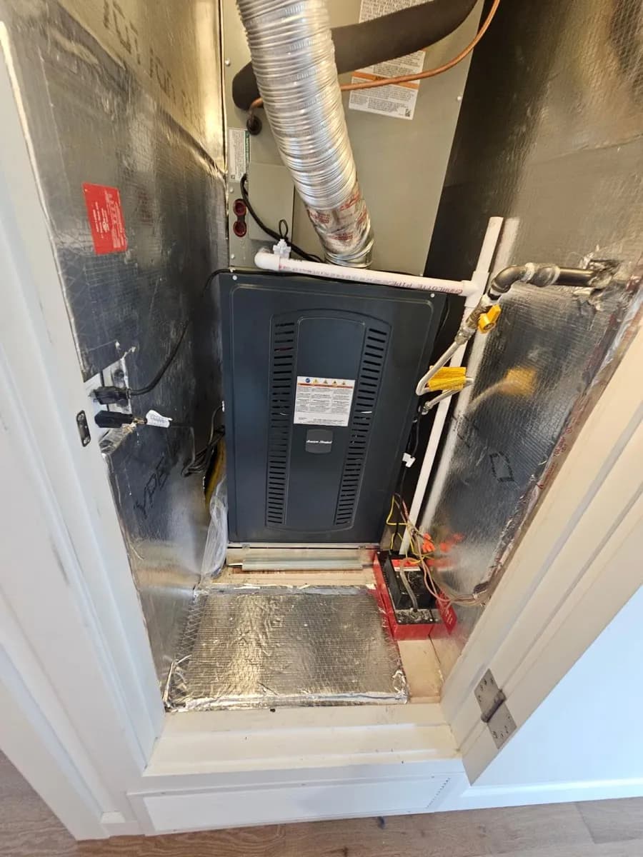 New furnace and evaporator coil installed by Season Control in a residential utility space with gas and refrigerant line connections