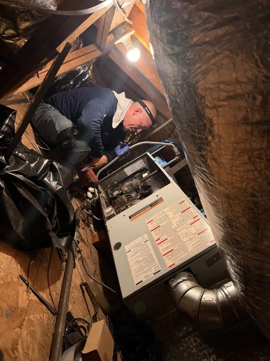 New high-efficiency furnace installed by Season Control in a residential utility closet with copper piping and gas line connections