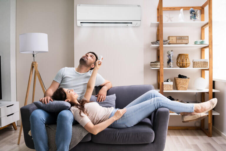 Young couple chilling on sofa looking at air conditioning in los angeles