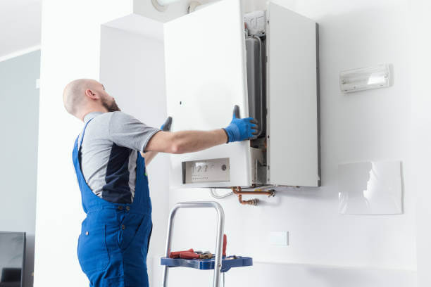 A man in overalls expertly repairs a gas boiler, ensuring its proper functioning and safety.